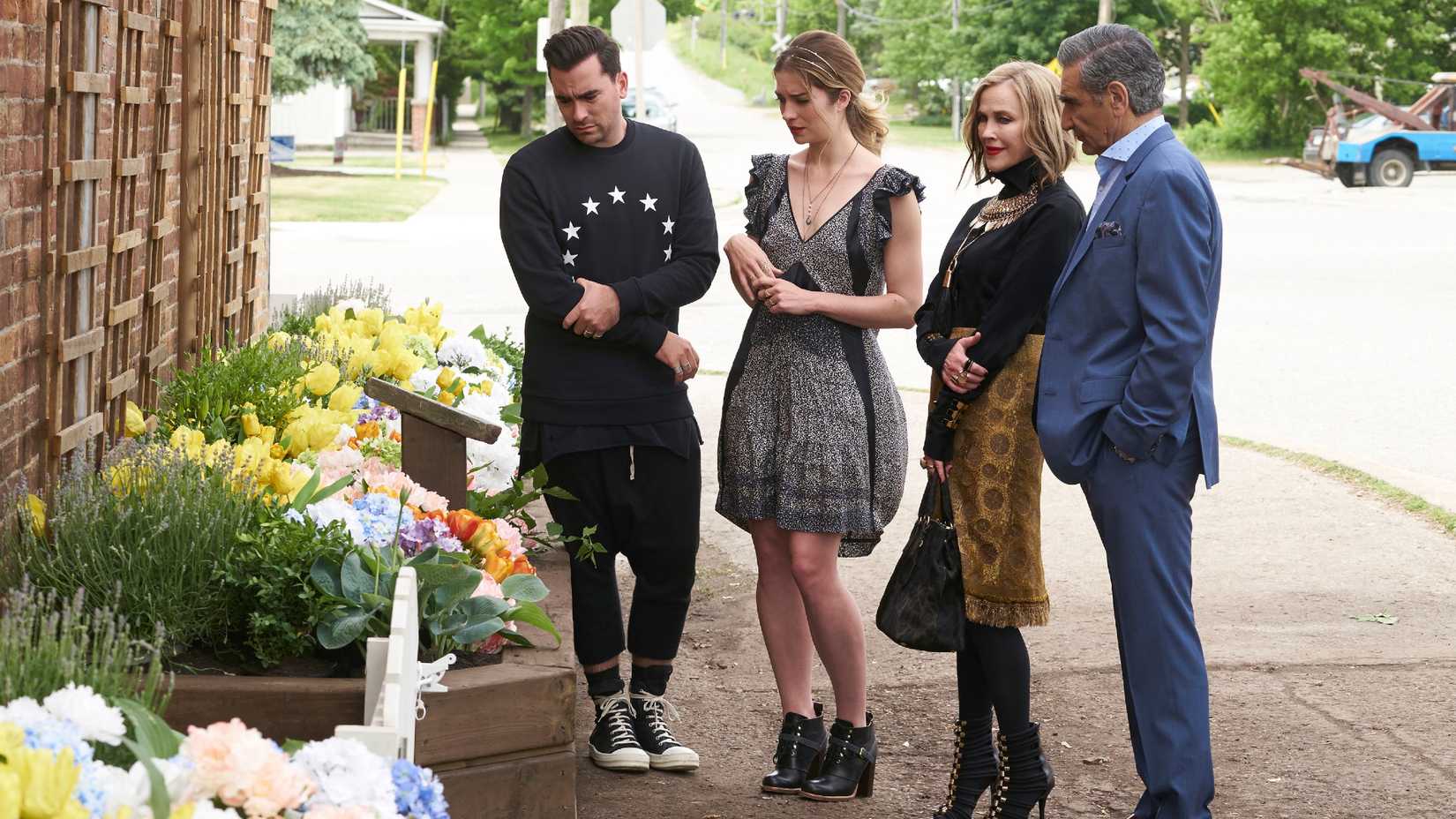The Roses Looking at a Flower Bed in Schitt's Creek