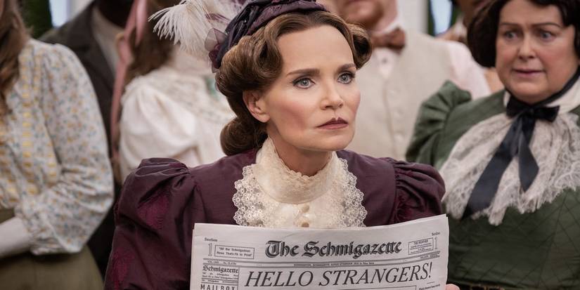 Kristin Chenoweth angrily holding a newspaper in Schmigadoon!