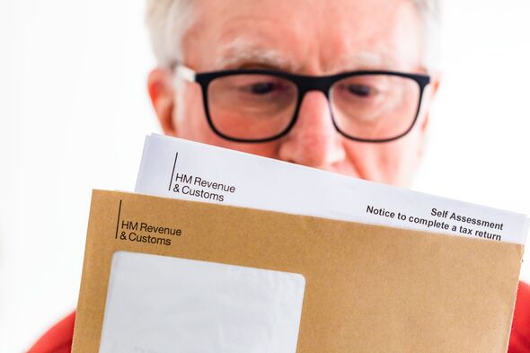 Senior man opening HMRC tax letter Senior man opening HMRC tax letter