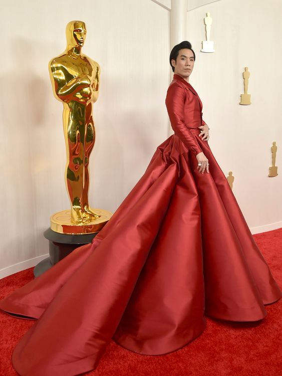 Eugene Lee Yang, channelling Billy Porter's tuxedo dress five years earlier, this time in red, designed by Walter Mendez. Pic: AP
