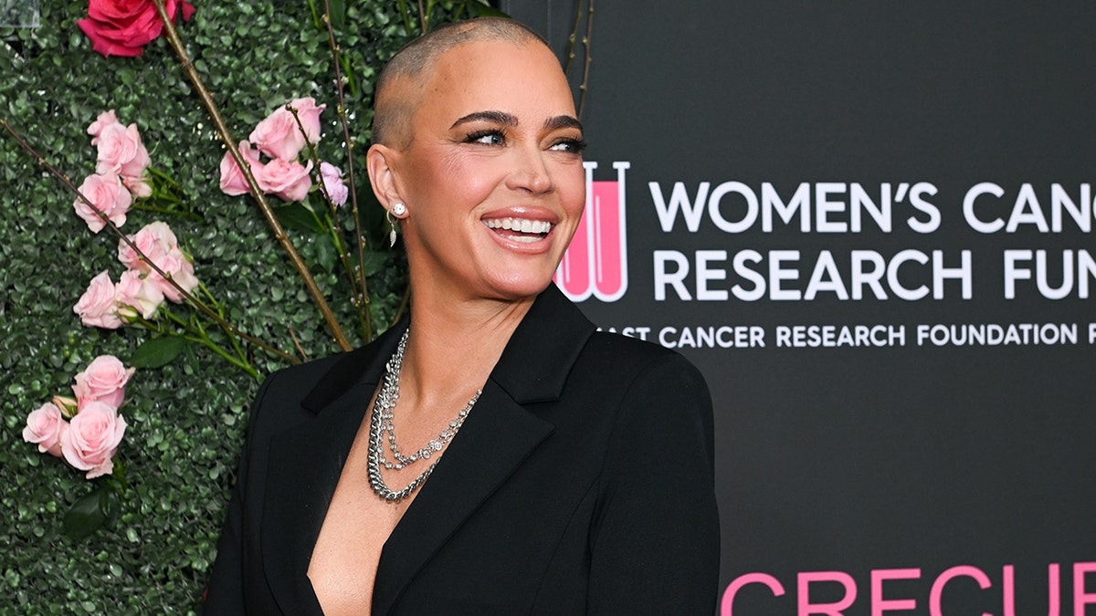 Teddi Mellencamp smiling with bald head