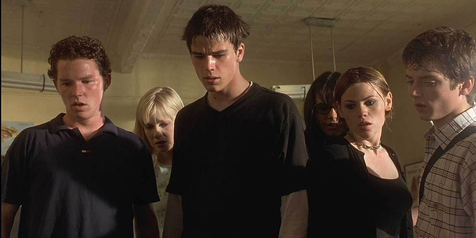 The cast of The Faculty stand over someone