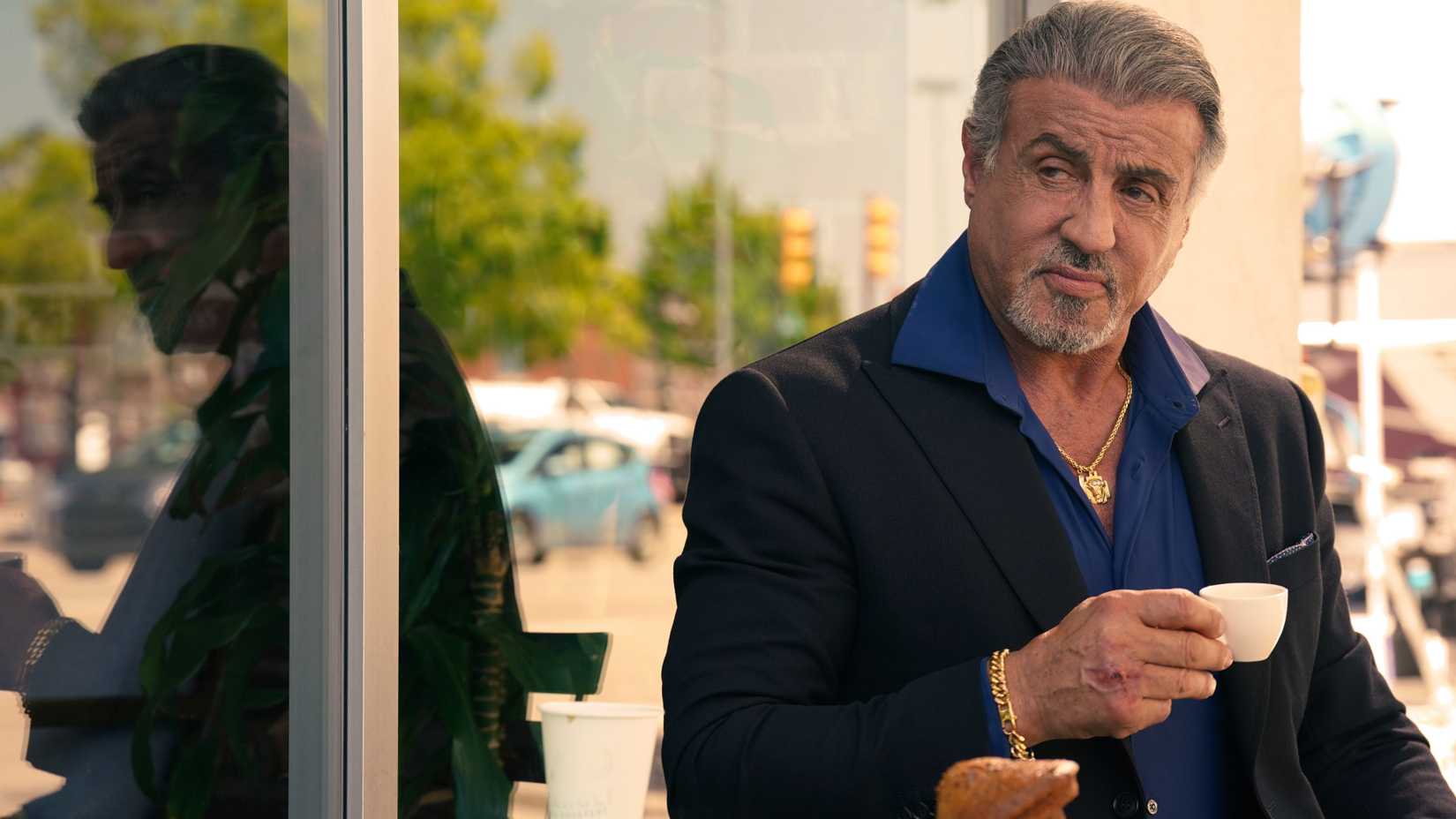 Sylvester Stallone as Dwight "The General" Manfredi drinking coffee in Tulsa King.
