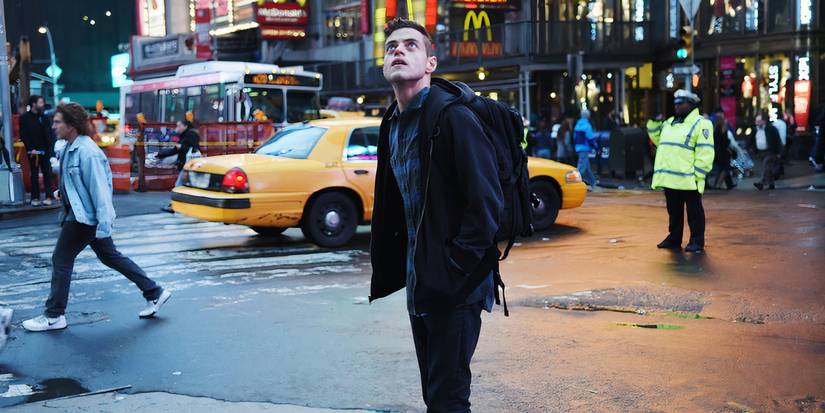 Rami Malek as Elliot Alderson looking up in a busy city street, surrounded by people and traffic, in Mr. Robot's pilot episode "eps1.0_hellofriend.mov."