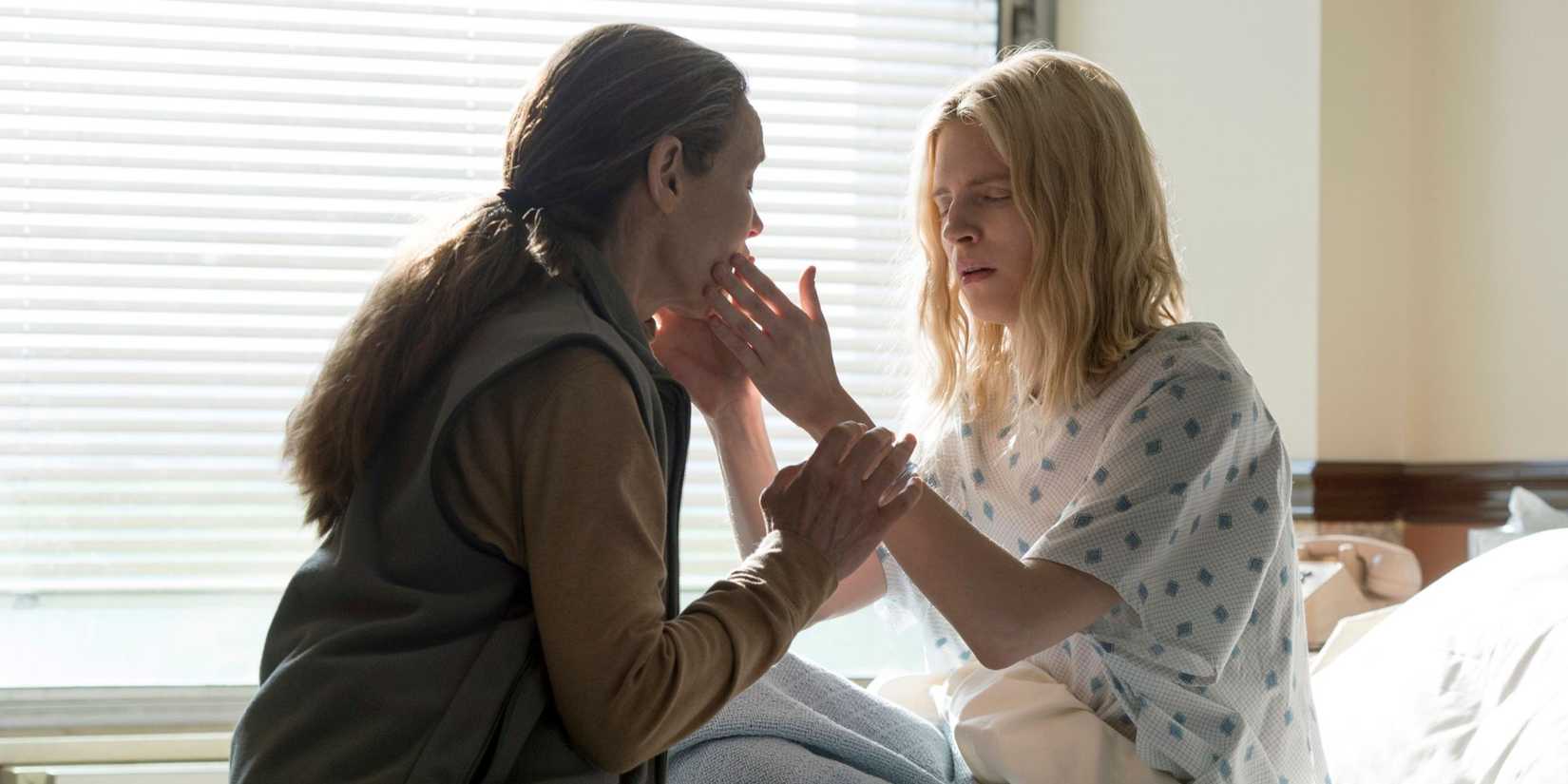Prairie in a hospital bed touching Nancy's face