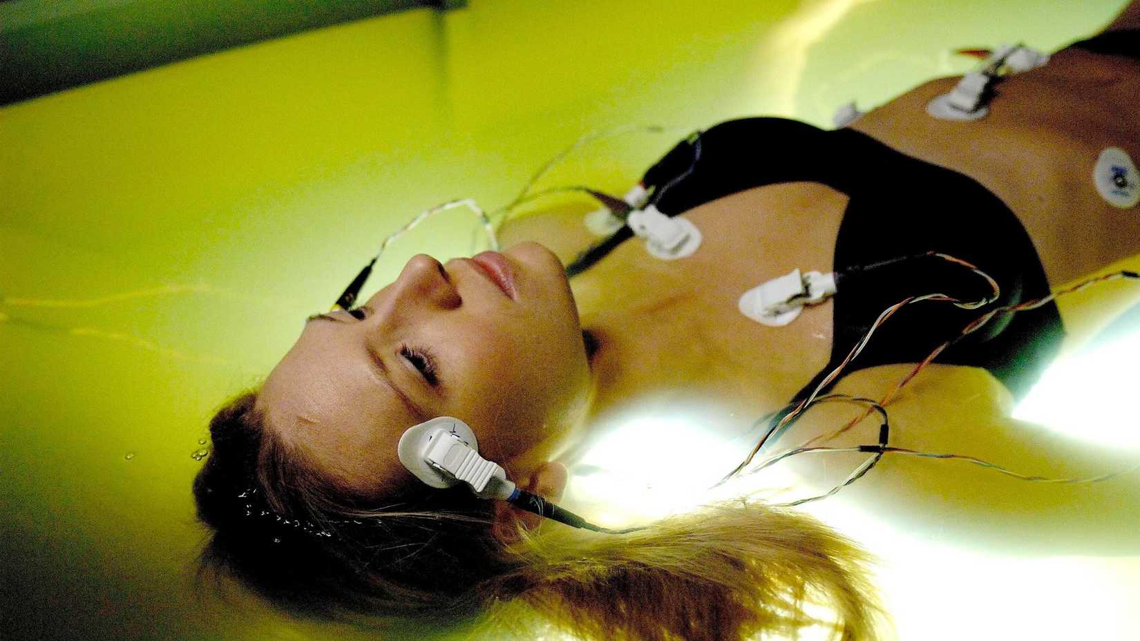 Anna Torv floating in a pool with monitoring pads in Fringe