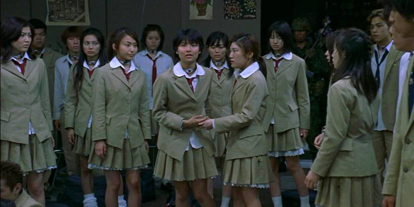 A group of students in junior high uniforms looking concerned in Battle Royale (2000)