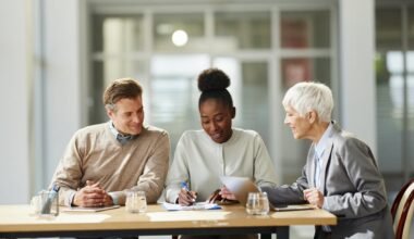 Professional sitting with clients in a meeting.