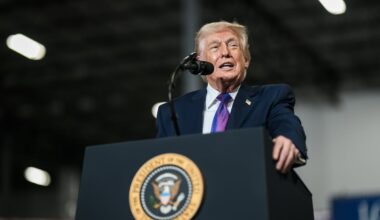Donald Trump delivering a speech at a manufacturing plant from behind the presidential podium.