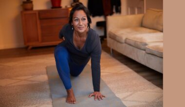 Woman doing 15-minute Pilates workout on yoga mat in living room