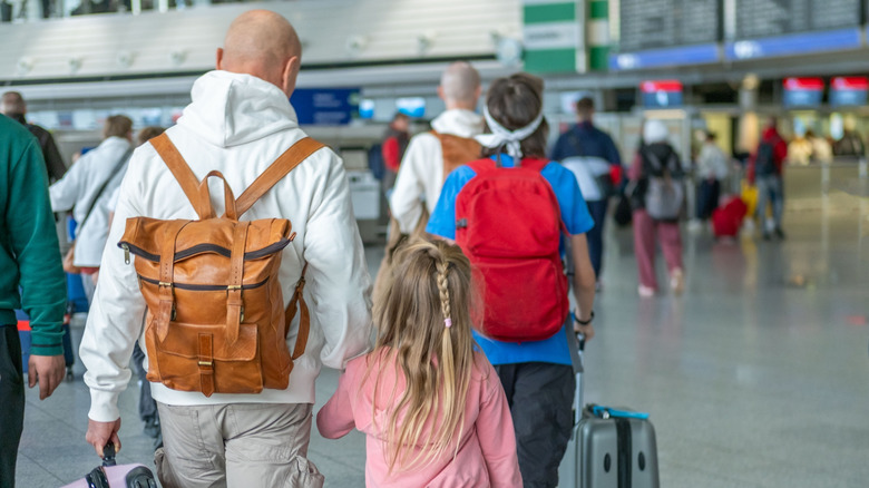 People walking through a busy airport