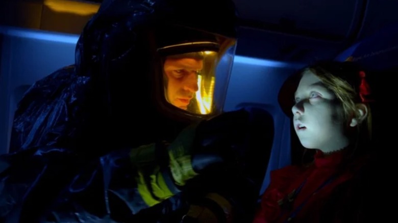 Corey Stoll as Dr. Ephraim Goodweather looking over a dead girl on a plane in The Strain