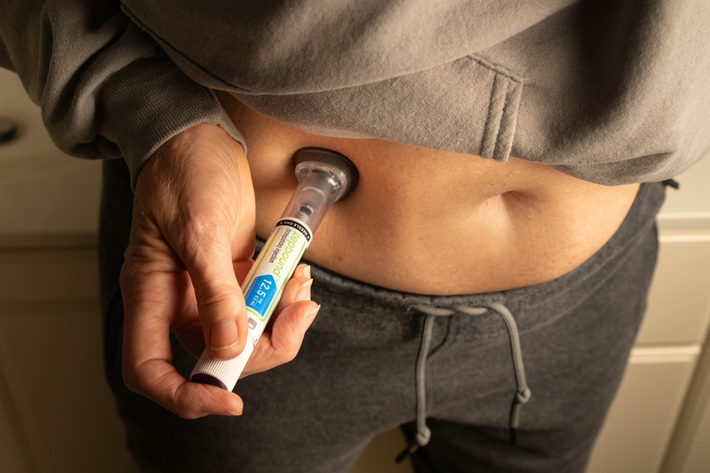 Woman self-administering a Zepbound injection into her abdomen