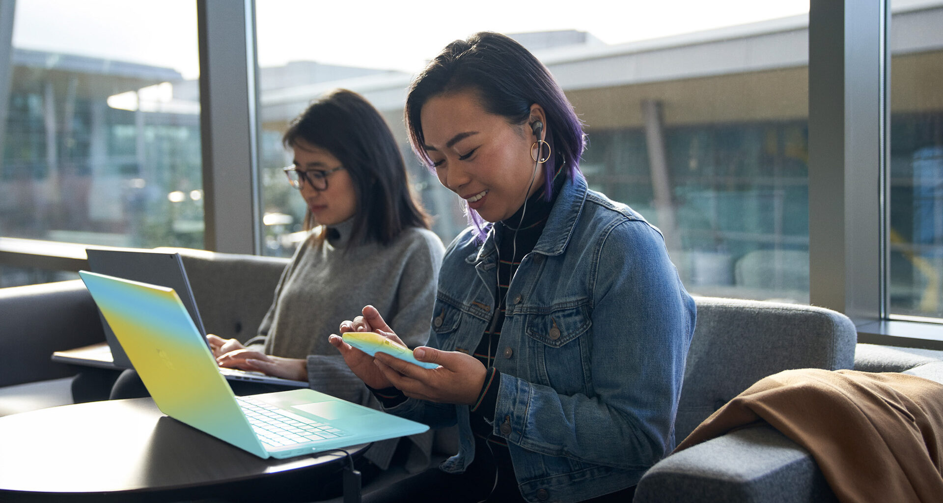 Two security workers sit at laptops.