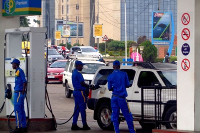 A pump attendant refills a car’s fuel tank (file photo).