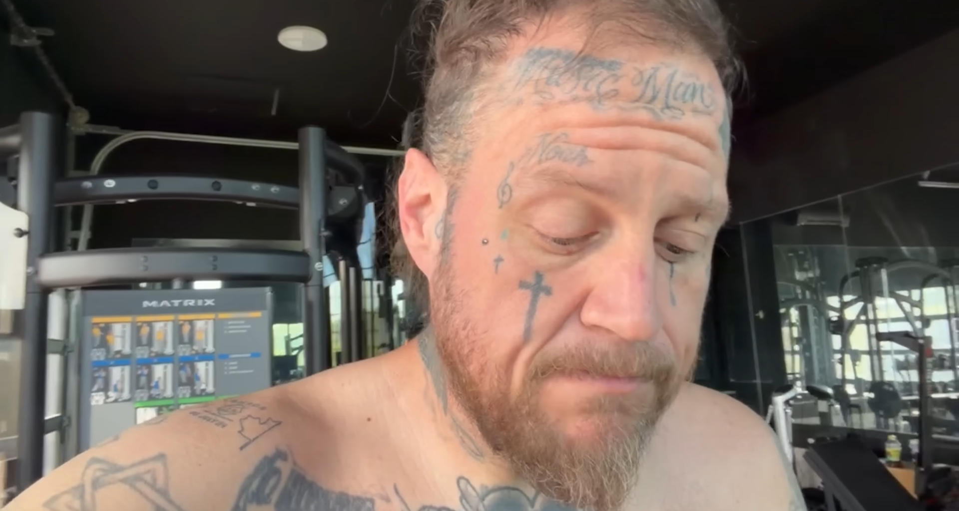 Jelly Roll looks anxious while shirtless.