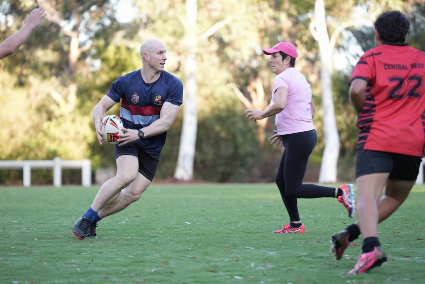 Senator Pocock plays touch footy at Parliament House.