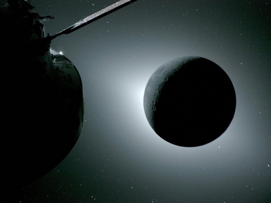 At left, part of a spacecraft. At right, the moon looking like a levitating black ball in front of a bright light source.