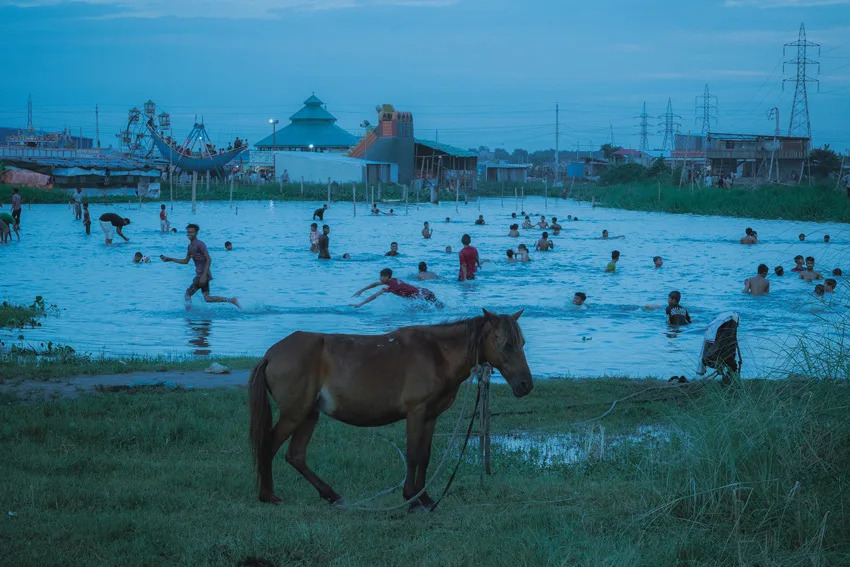 In Dhaka, Bangladesh, Arnob photographed the Balu River, now a makeshift playground. A solitary horse watches quietly as people gather, reclaiming joy and togetherness amid a vanishing landscape