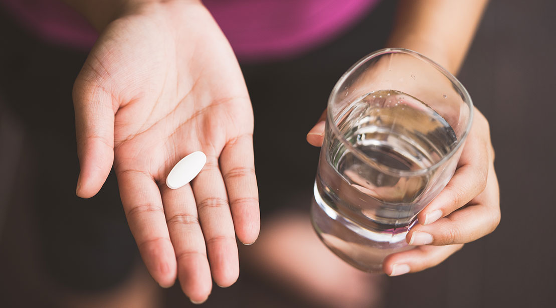 Woman Taking Supplement