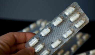 A photo of a person holding a blisterpack of Neurontin capsules.