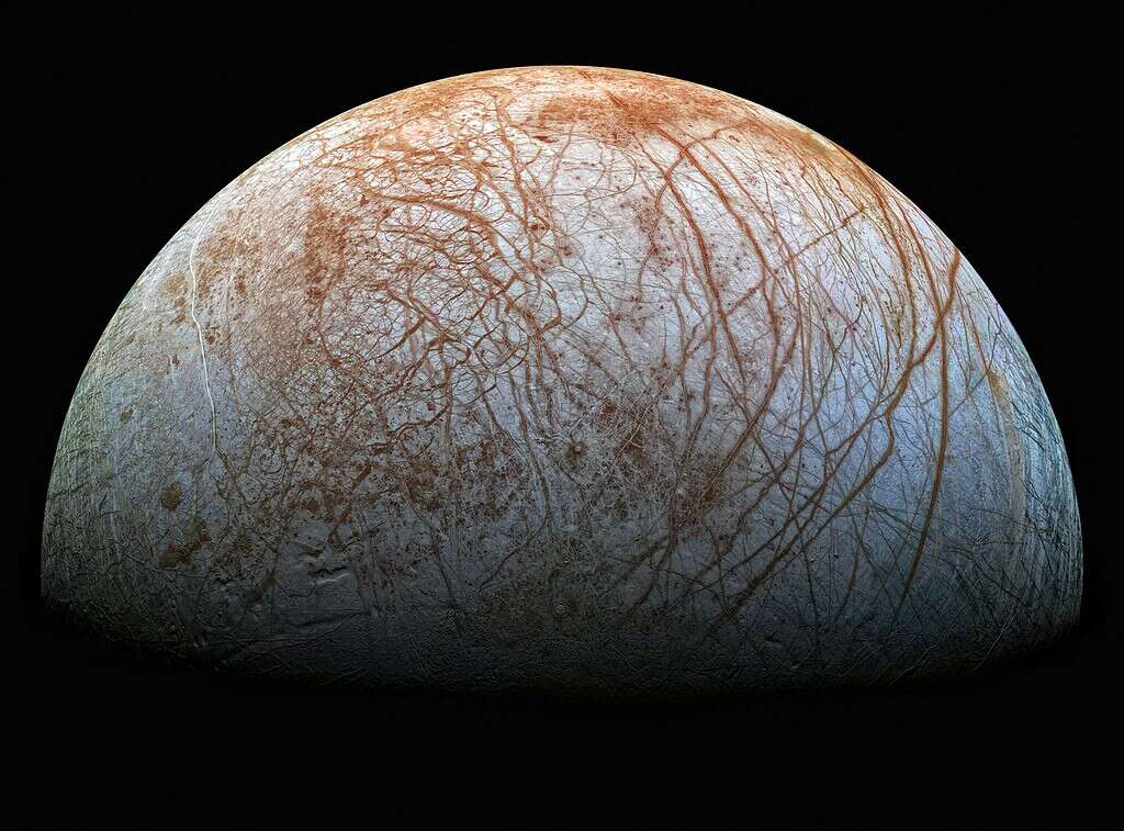 Image of Jupiter's moon Europa showing ice and reddish-brown streaks.