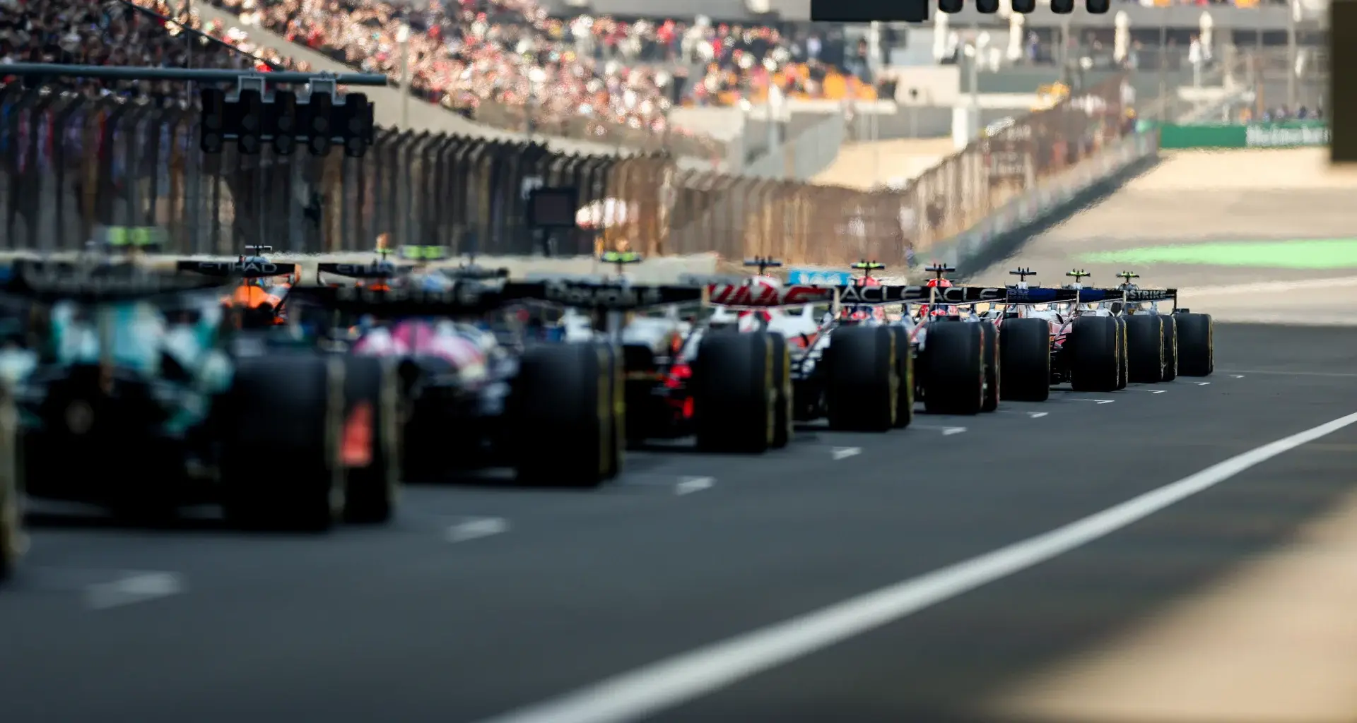 SUZUKA, JAPAN - MARCH 29: Fernando Alonso of Spain and Aston Martin F1 Team talks on the grid