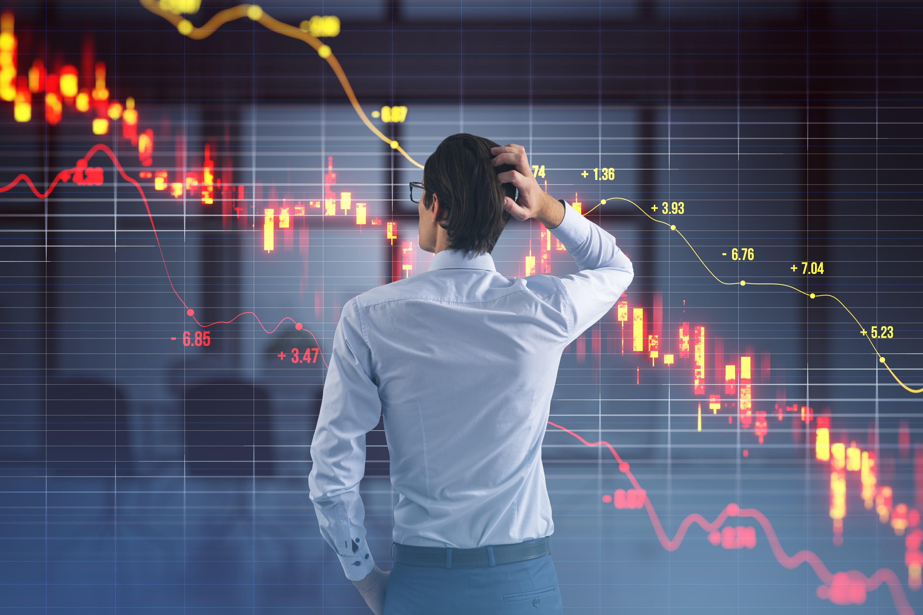 Investor looking at a declining stock chart.