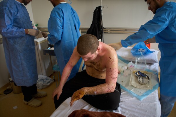A man with burn wounds from an Israeli airstrike on southern Lebanon undergoes surgery by Dr. Mohammed Ziara and his team, at the Sidon Government Hospital in Sidon, Lebanon, Thursday, April 2, 2026. (AP Photo/Emilio Morenatti)