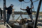 Jaden Gilliam, OceanWell project engineer, left, and Mark Golay, director of engineering projects, lower a prototype reverse osmosis pod into Las Virgenes Reservoir in Westlake Village, Calif., Monday, Dec. 1, 2025. (AP Photo/Annika Hammerschlag)