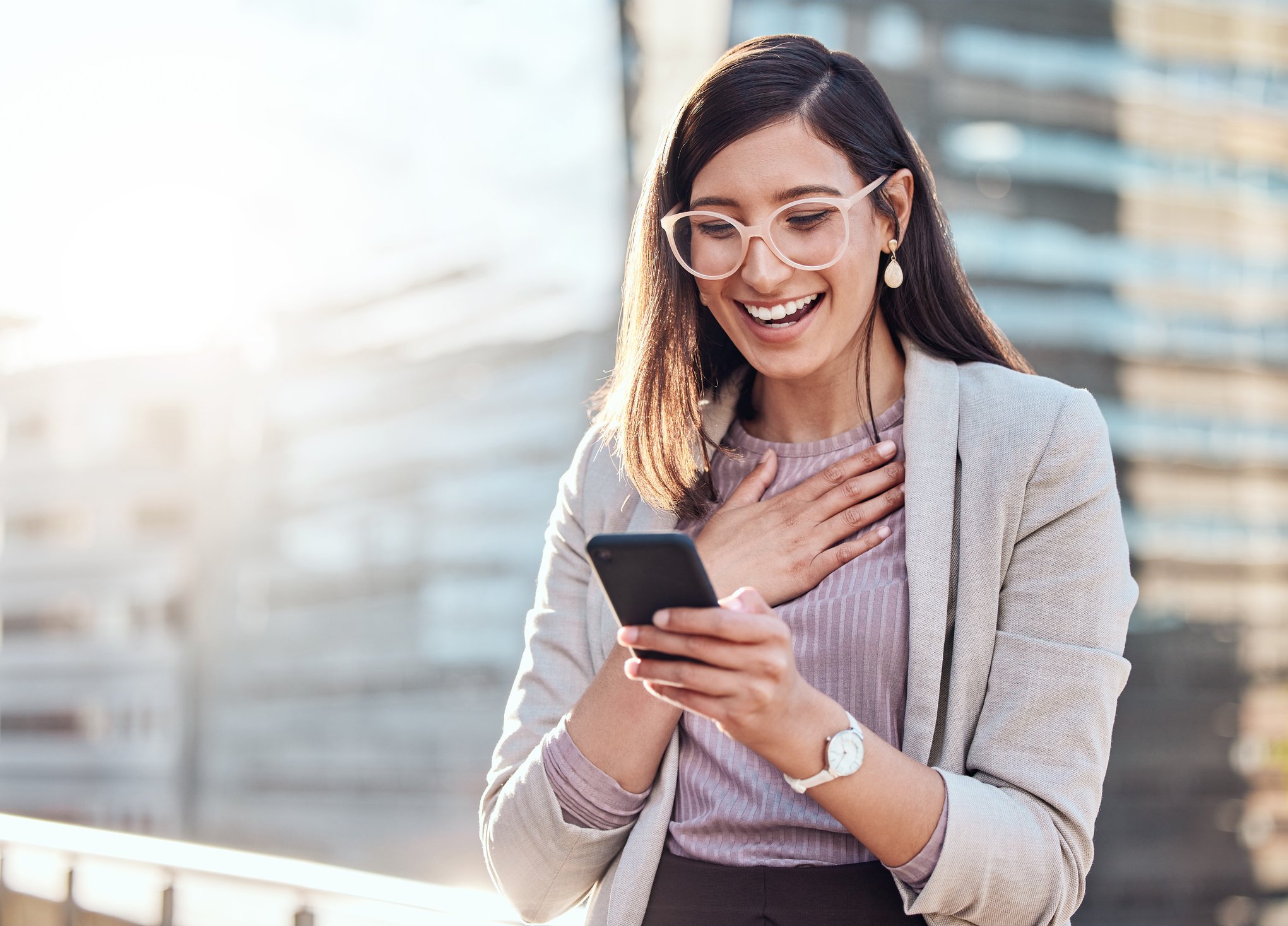 A person looks surprised while using a smartphone.