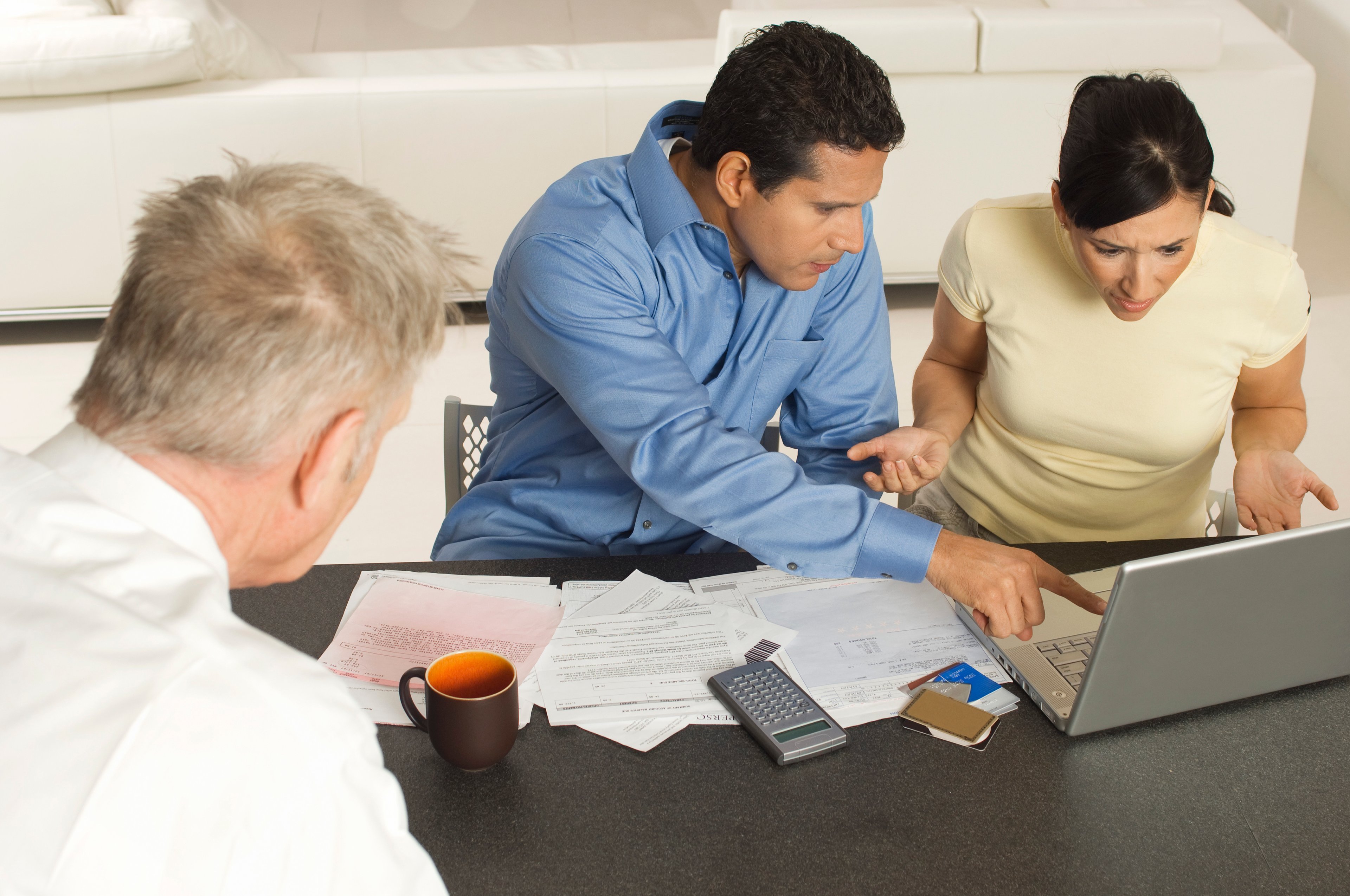 Three people working at a table.