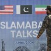 A Pakistani Ranger walks past a billboard for the U.S.-Iran peace talks in Islamabad on April 12, 2026. The talks, led by Vice President JD Vance, produced no concrete movement toward a peace deal.