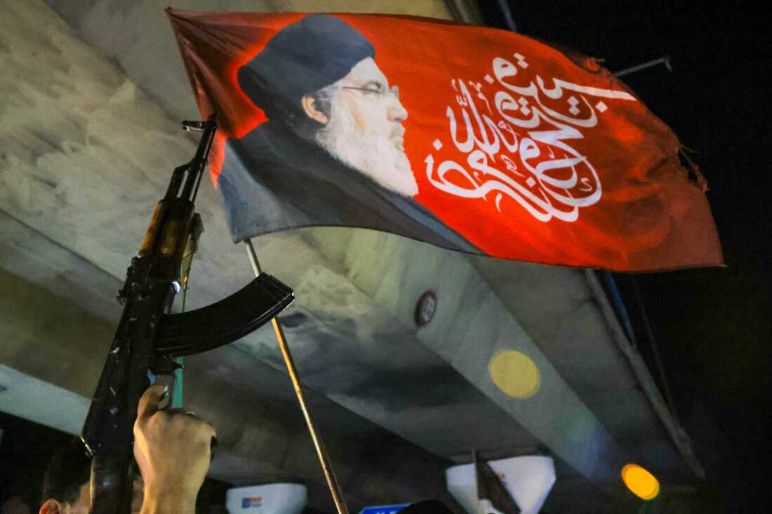 A supporter of Hezbollah holds a machine gun while celebrating the ceasefire with Israel as it takes effect in the sountern suburbs of Beirut early on April 17, 2026. Gunfire erupted in Beirut's southern suburbs as a ceasefire with Israel came into effect at midnight on April 17 (2100 GMT Thursday), according to AFP journalists and AFPTV footage. State media also reported "heavy gunfire" accompanying the start of the 10-day truce, announced earlier by US President Donald Trump. (Photo by ibrahim AMRO / AFP via Getty Images) /