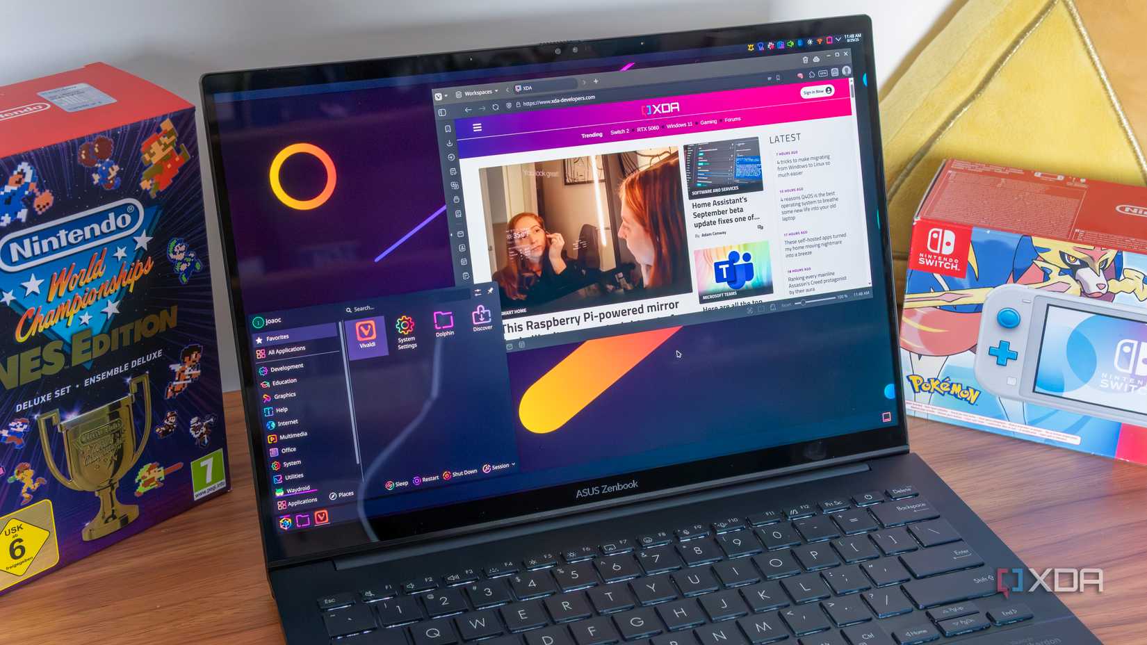 A laptop running Linux with KDE Plasma showing the app launcher and a Vivaldi window with the XDA home page