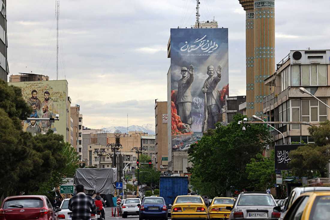 Commuters drive past a giant billboard referring to the Strait of Hormuz along a busy street in Tehran, Iran, on Sunday.