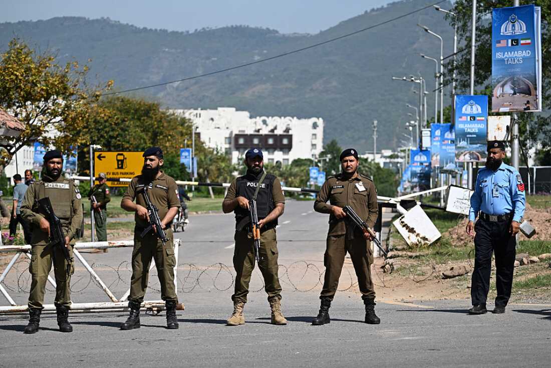 Security personnel stand guard at a security checkpost along a road temporarily closed near the Serena Hotel at the Red Zone area in Islamabad on Monday, ahead of anticipated U.S.-Iran peace talks.