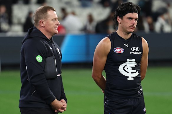 Elijah Hollands (right) with Blues coach Michael Voss after the loss to Collingwood.