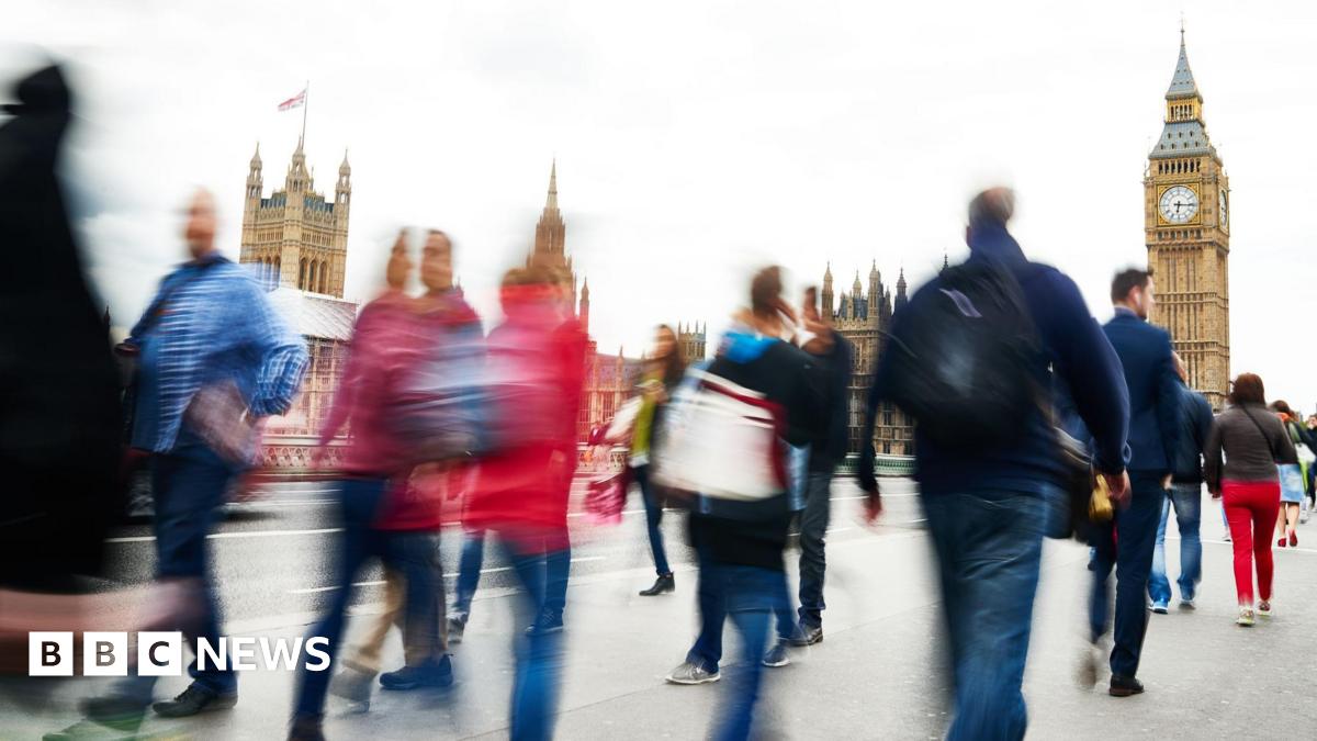 People walking in front of the Houses of Parliament in London