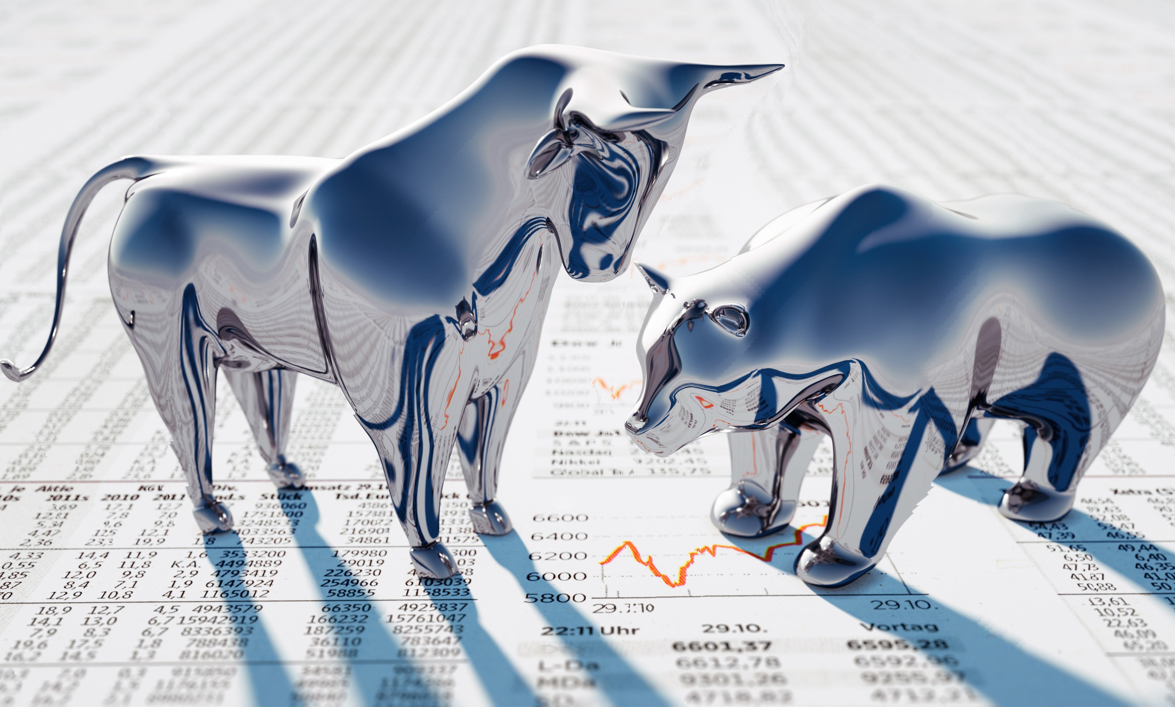 A silver bull towers over a silver bear, both of which stand on newsprint.