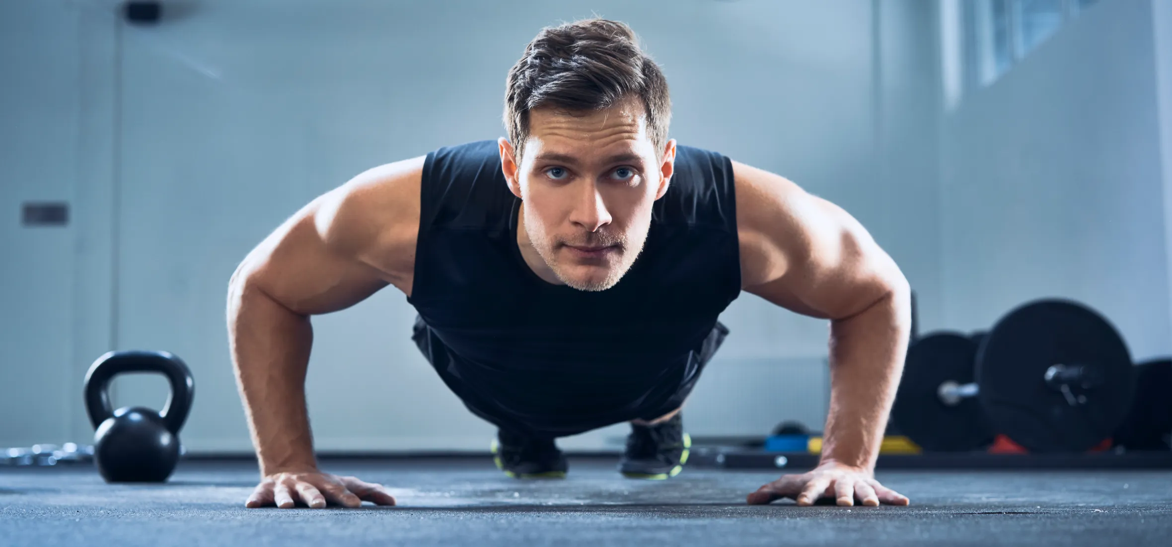 Man doing push-up exercise at gym.