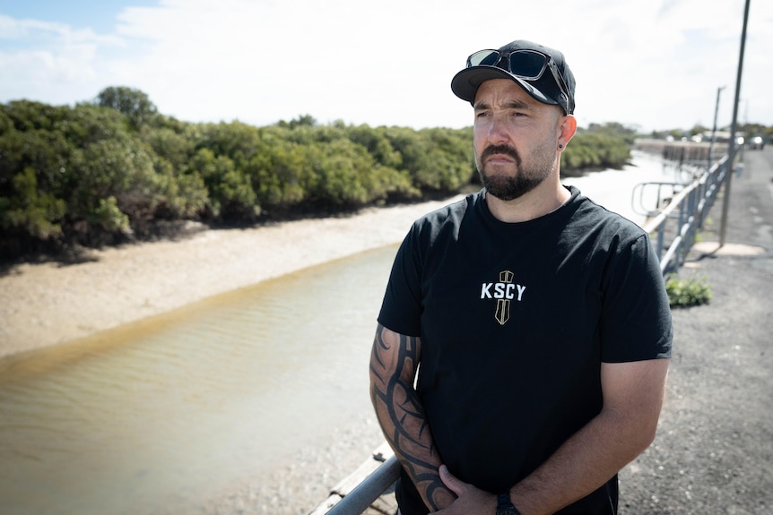 A commercial fisher in a cap and t-shirt.