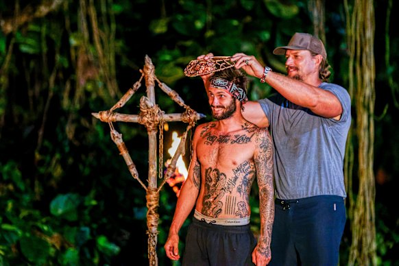 Caleb Beeby is given the immunity necklace by host David Genat after winning the final challenge.