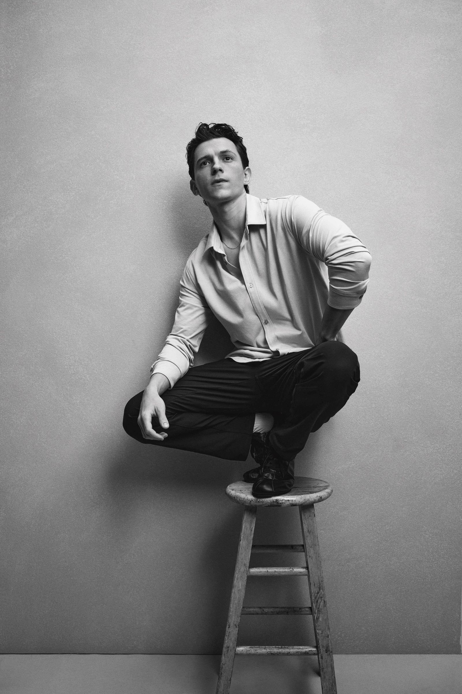 Image may contain Tom Holland Photography Face Head Person Portrait Sitting Bar Stool Furniture Adult and Happy