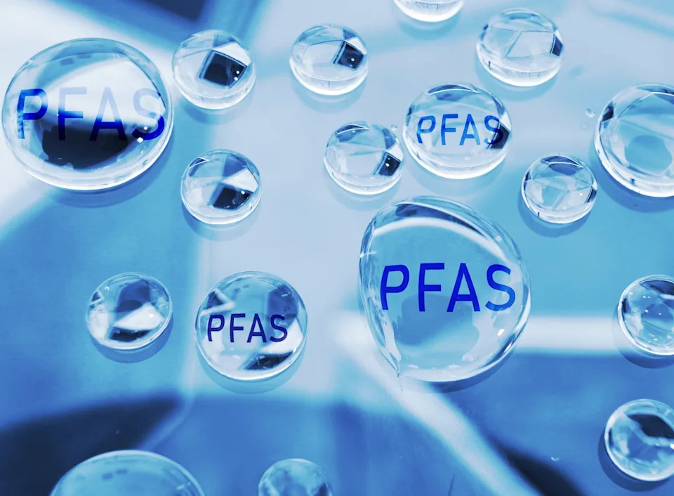 Water droplets on a surface labeled "PFAS," illustrating the presence of chemicals often found in various household products
