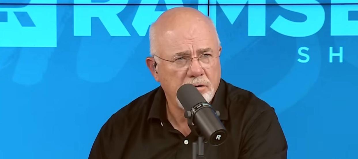 Dave Ramsey speaks into a microphone, looking concerned.