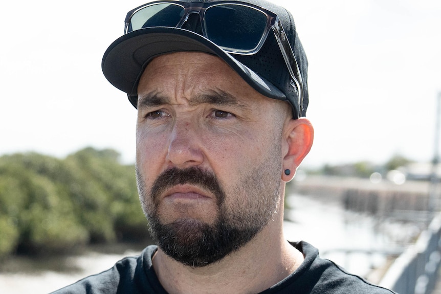 A commercial fisher in a cap and t-shirt.