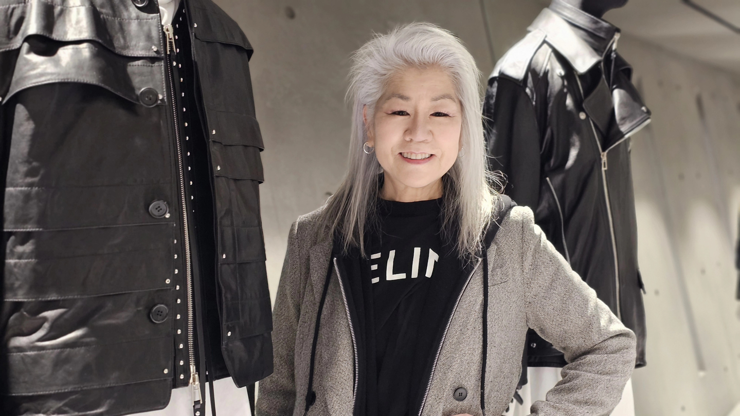 Kat Turner, a Korean American ARMY, poses for photos beside mannequins displaying stage costumes worn by BTS members at Gallery Noir Songzio in Gangnam, southern Seoul, on March 31. The costumes, designed by Songzio, were worn by the members during the “BTS The Comeback: Live” performance at Gwanghwamun Square in central Seoul on March 21. [SHIN HA-NEE]