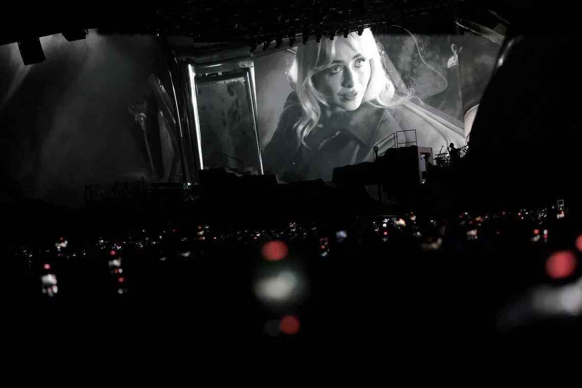 Sabrina Carpenter appears on the screen as she performs at the Coachella Valley Music and Arts Festival in Indio, California, U.S., April 10, 2026.