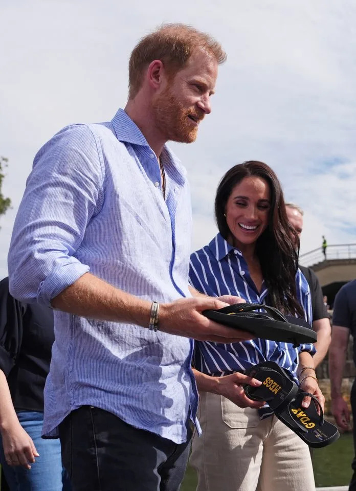 Prince Harry and Meghan Markle at a sailing event in Australia on April 17.Credit: Getty Images